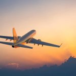 passenger-airplane-flying-above-clouds-during-sunset-picture-id155439315.jpg